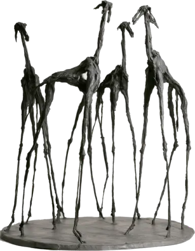Bronze sculpture of four elongated walking figures on an oval base.